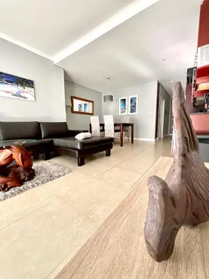 a living room with a dinosaur fossil on the floor at 502 Portico in Cape Town