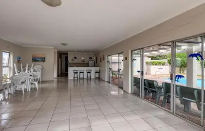 a large living room with a table and chairs at 30 Nagua Bay in Cape Town