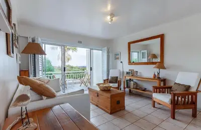 a living room with a couch and a table at 30 Nagua Bay in Cape Town