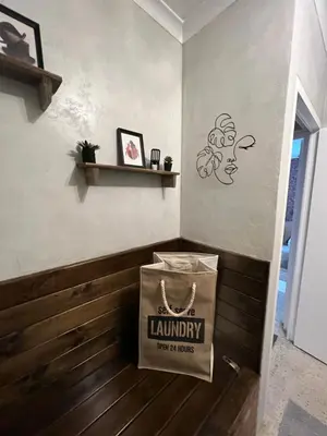 a bag of laundry sitting on the wall of a room at TnT on Main in Hermanus