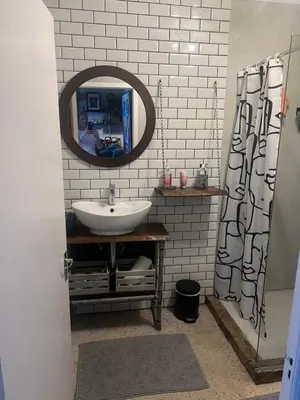 a bathroom with a sink and a mirror at TnT on Main in Hermanus