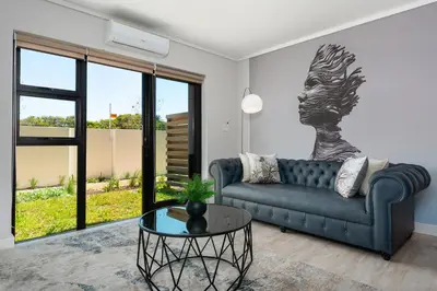 a living room with a couch and a table at Burmeister on Park Apartments in Cape Town