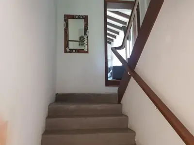 a stairway with a mirror and a mirror at Relax on Blair in Cape Town