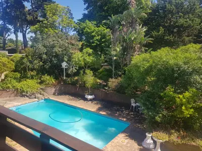 an overhead view of a swimming pool in a garden at Relax on Blair in Cape Town