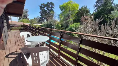 a patio with a table and chairs on a deck at Relax on Blair in Cape Town