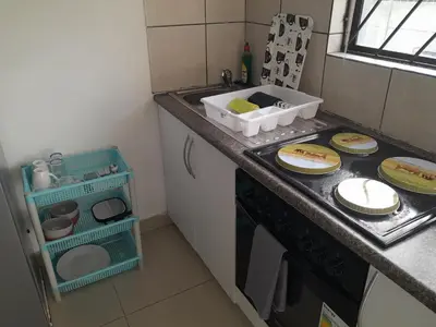 a kitchen with a counter with plates on a stove at Oxford Getaway-House in Cape Town
