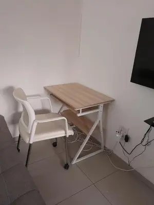 a desk and a white chair and a table and a television at Oxford Getaway-House in Cape Town