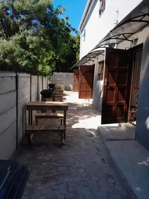 a group of benches sitting next to a building at Oxford Getaway-House in Cape Town
