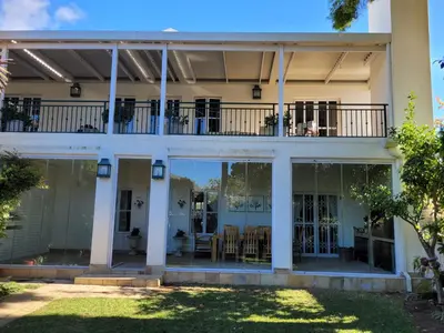 a house with large windows and a balcony at Stellenbosch Paradyskloof Unit in Stellenbosch