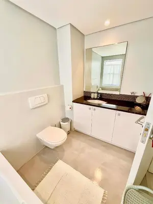 a bathroom with a toilet and a sink at 706 Portico in Cape Town