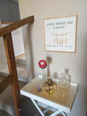 a table with a vase of flowers on top of it at Prince Alfreds in Caledon
