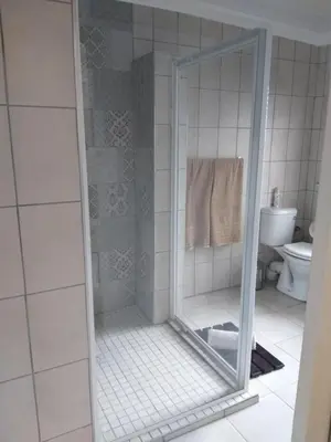 a shower with a glass door in a bathroom at Prince Alfreds in Caledon