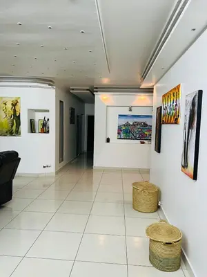 a room with paintings and baskets on the walls at African Haven Guest House in Cape Town