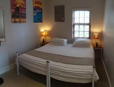 a bed in a bedroom with two pillows and a window at Harbour House Hotel - Adventure Pads in Hermanus