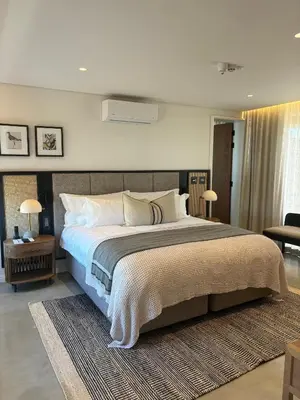 a bedroom with a large bed in a room at Vergenoegd Löw Boutique Hotel & Spa in Somerset West