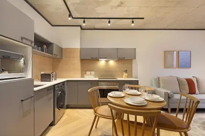 a kitchen and dining room with a table and chairs at Bridgewater View 502 in Cape Town