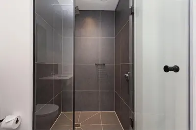 a shower with a glass door in a bathroom at Bridgewater View 502 in Cape Town