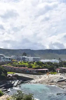a city with a beach and buildings and a river at Hermanus Waterfront Apartment No.19 in Hermanus