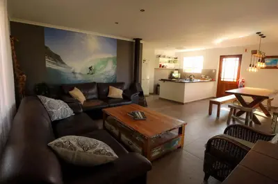 a living room with a couch and a table at Surfhostel Cape Town in Cape Town