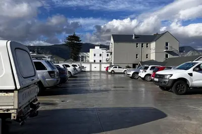 a parking lot with a lot of cars parked at Hermanus Waterfront Apartment No.20 in Hermanus