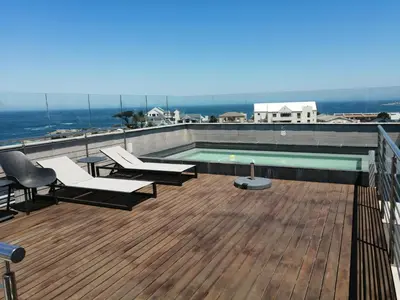 a swimming pool on the roof of a building at Hermanus Waterfront Apartment No.20 in Hermanus