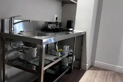 a kitchen with a sink and a counter top at Hermanus Waterfront Apartment No.20 in Hermanus