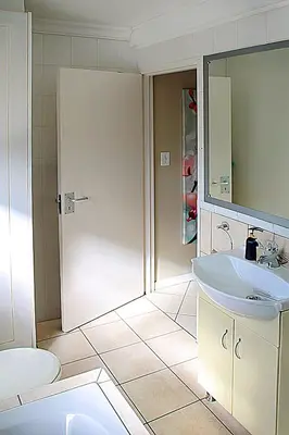 a bathroom with a toilet and a sink at OCEAN VIEW, Blouberg Beach, Sunsets & Kite Beach in Bloubergstrand