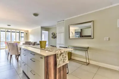 a kitchen with a counter and a mirror on the wall at 2 Bedroom Apartment in Century City 204QS in Cape Town