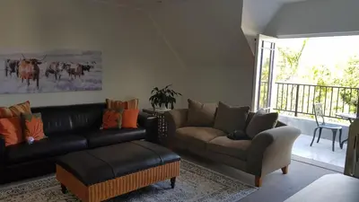a living room with a couch and a chair at Mountain View Self-Catering Apartments in Somerset West