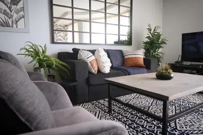 a living room with a couch and a coffee table at Beachfront Gem / Free Parking / A/C in Cape Town