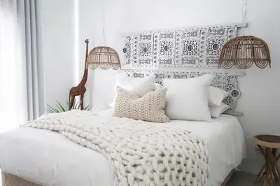 a bedroom with a white bed with white pillows at Quiet hidden gem in historic Stellenbosch in Stellenbosch