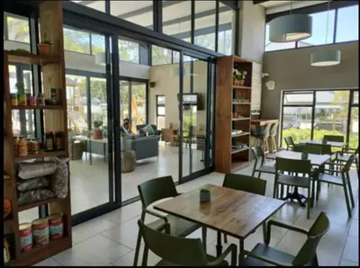 a restaurant with tables and chairs in a room at Casa The Jade in Cape Town