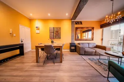 a living room with a table and a couch at Blouberg Beach Luxury Apartment in Cape Town