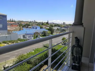 a balcony with a view of a city at Blouberg Beach Luxury Apartment in Cape Town