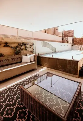 a room with two large tubs and a table at Villa Visser in Cape Town