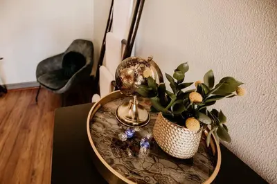 a table with a vase with a plant on it at Villa Visser in Cape Town
