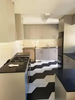 a kitchen with a black and white checkered floor at Capetown Adilo Villa in Cape Town