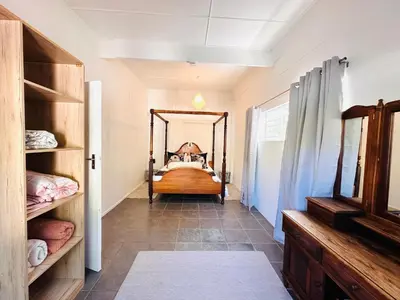 a bedroom with a bed and a large mirror at 2-Bedroom Hermanus - Sleeps 4 - Near Sea in Hermanus