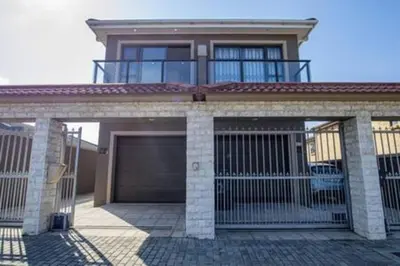 a house with a gate and a garage at Howard Davis 28B by CTHA in Cape Town