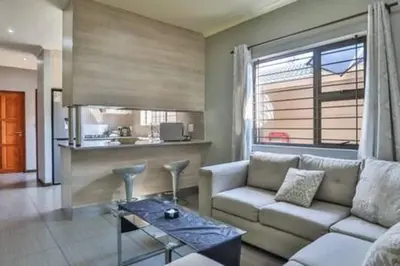 a living room with a couch and a table at Howard Davis 28B by CTHA in Cape Town