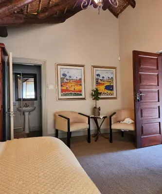 a bedroom with a bed and a table and chairs at Traduire in Cape Town