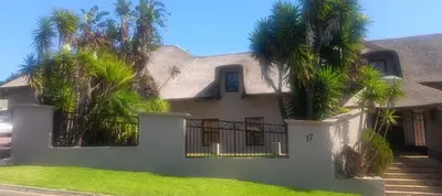 a house with palm trees in front of it at Traduire in Cape Town