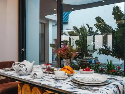 a table with plates and cups on it with a table cloth at Boutique Ocean Views - incorporating Wendy's in Hermanus