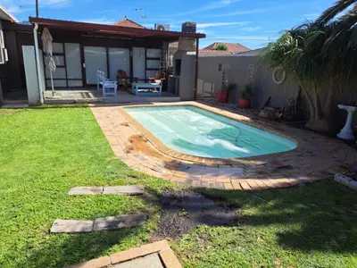 a swimming pool in the yard of a house at 68 On Hofmeyr in Strand