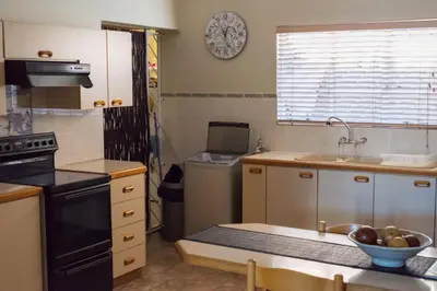 a kitchen with a sink and a stove top oven at 68 On Hofmeyr in Strand
