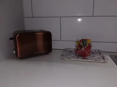 a kitchen counter with a toaster and a plate of food at Cederberg Estate in Cape Town