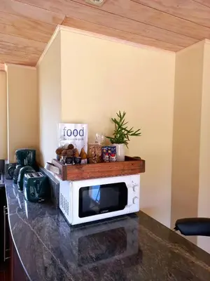 a microwave sitting on top of a counter at Basco River Lodge Luxury Apartment in Grabouw