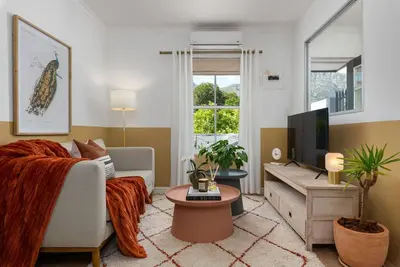 a living room with a couch and a tv at The Tram Stop in Franschhoek