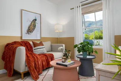 a living room with a couch and a window at The Tram Stop in Franschhoek