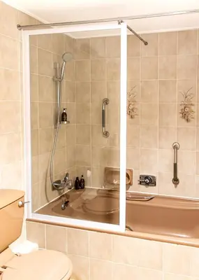 a bathroom with a bath tub and a toilet at Bayview 305A in Hermanus